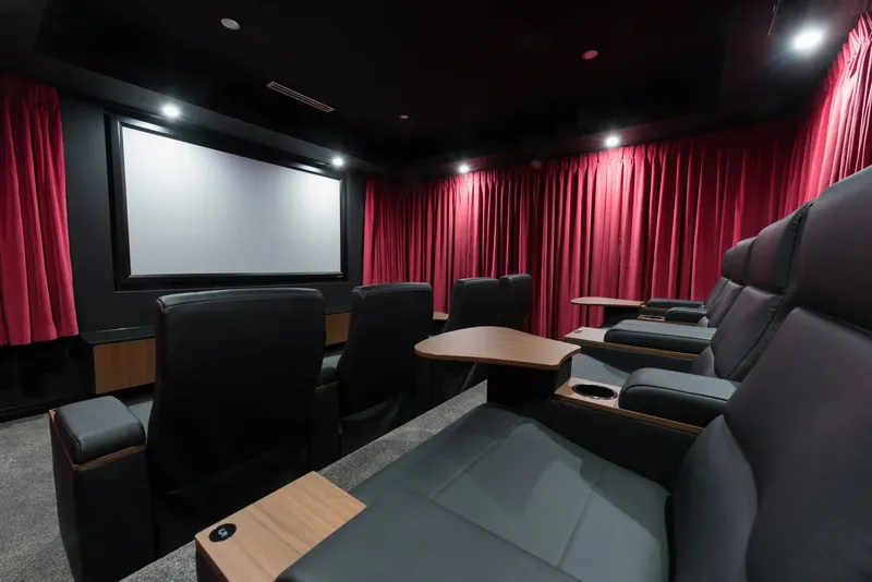 Palmers TV home cinema installation in Canberra — projector screen, leather recliner seating, premium acoustic treatment