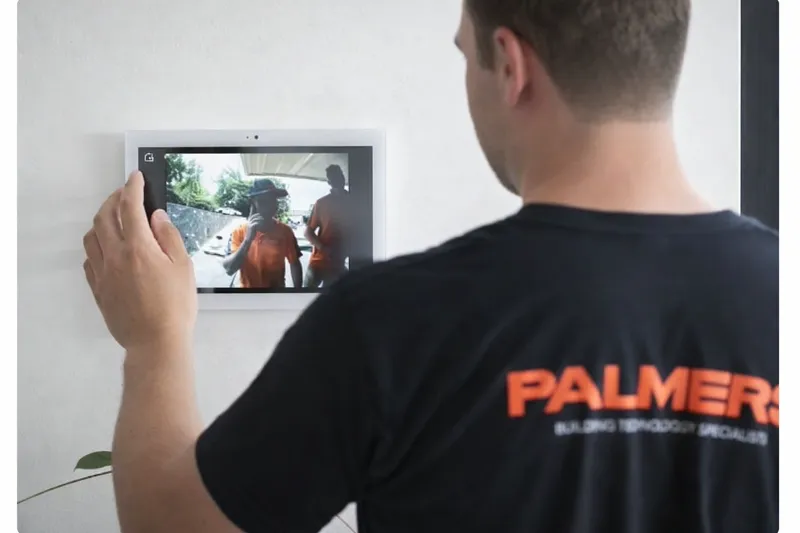 Palmers TV technician using video intercom security system in Canberra home